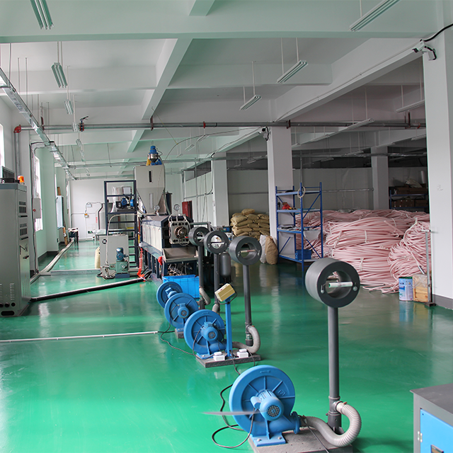 Workers operating machinery in Lukwom's manufacturing workshop
